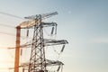 Power transmission tower and chimney at dusk Royalty Free Stock Photo