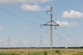 Power Transmission Towers. Air hi-voltage electric line supports at field under blue sky. Royalty Free Stock Photo