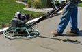 Power trowel smoothening drying concrete on a garage floor Royalty Free Stock Photo