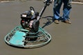 Power trowel smoothening drying concrete on a garage floor Royalty Free Stock Photo