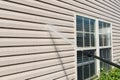 Power washing. House wall siding cleaning with high pressure water jet. Royalty Free Stock Photo