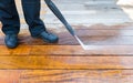 Power washing - man cleaning terrace with a power washer - high water pressure cleaner on terrace surface Royalty Free Stock Photo