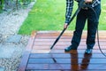 Power washing - man cleaning terrace with a power washer - high water pressure cleaner on terrace surface Royalty Free Stock Photo