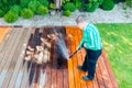 Power washing - man cleaning terrace with a power washer - high water pressure cleaner on terrace surface