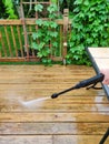 Power washing. Wooden deck floor cleaning with high pressure water jet Royalty Free Stock Photo