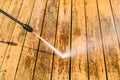 Power washing. Wooden deck floor cleaning with high pressure water jet. Royalty Free Stock Photo