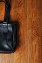 Black notebook peeking out of the pocket of a black leather bag close-up, macro Handmade, natural materials