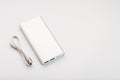 Powerbank for charging mobile devices with cable, on a white background Royalty Free Stock Photo