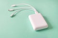 Powerbank on green background. Powerbank with different connectors. Royalty Free Stock Photo