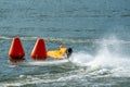 Powerboat rounding a marker buoy in a race Royalty Free Stock Photo