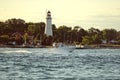 Powerboat by lighthouse on the river