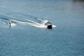 A powerboat pulling a water skier on a lake. Royalty Free Stock Photo