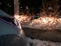 Powered on car headlights expose snowy roadside