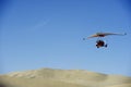 Powered glider flying above the desert