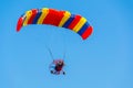 Powered Paraglider in a blue sky