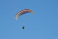 Powered Paraglider isolated in blue sky.