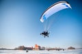 Powered Paraglider in winter over ice covered lake