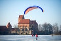 Powered Paraglider in winter over ice covered lake