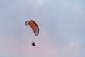 Powered paragliding, man flying high in a sky with parachute and engine on his back Royalty Free Stock Photo