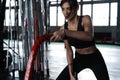 Powerful attractive muscular woman CrossFit trainer do battle workout with ropes at the gym Royalty Free Stock Photo