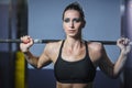 Powerful attractive muscular woman CrossFit trainer do workout with barbell