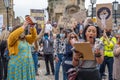 A powerful black woman rallies, with her supporters in the background, at a Black Lives Matter protest in Richmond, North