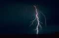 Powerful bolt of lightning with many side branches strikes down in a lake Royalty Free Stock Photo