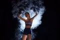Powerful boxer girl in shorts and gloves vining pose, symbolizing strength and competitiveness in sports against black
