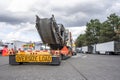 Powerful classic big rig semi truck carry on step down semi trailer oversized cargo standing on the truck stop parking lot with Royalty Free Stock Photo