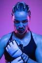 Close-up portrait of athletic girl MMA fighter isolated on blue background Royalty Free Stock Photo