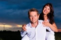 Powerful couple in front of windmill Royalty Free Stock Photo