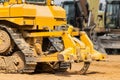 Powerful crawler bulldozer close-up at the construction site. Construction equipment for moving large volumes of soil. Modern Royalty Free Stock Photo