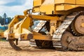 Powerful crawler bulldozer close-up at the construction site. Construction equipment for moving large volumes of soil. Modern Royalty Free Stock Photo