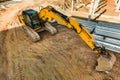 A powerful crawler excavator is working on a construction site. Close-up. View from above. Preparation of a pit for construction. Royalty Free Stock Photo