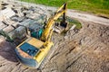 A powerful crawler excavator is working on a construction site. Close-up. View from above. Preparation of a pit for construction. Royalty Free Stock Photo