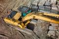 A powerful crawler excavator is working on a construction site. Close-up. View from above. Preparation of a pit for construction. Royalty Free Stock Photo