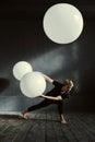 Powerful dancer performing in front of the dark wall