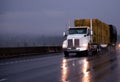 Powerful day cab big rig semi truck transporting pressed hay on Royalty Free Stock Photo