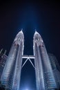 Low-Angle Shot of the Iconic Petronas Twin Towers and Skybridge, Brilliantly Illuminated Against the Dark Night Sky Royalty Free Stock Photo
