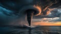 Dramatic waterspout touching down at sea with stormy sky and sunset glow Royalty Free Stock Photo