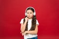 Powerful effect music teenagers their emotions, perception of world. Girl listen music headphones on red background Royalty Free Stock Photo