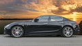 Powerful and elegant with beautiful modern design of fast and luxury Italian sedan car Maserati Ghibli in gunmetal color, produced
