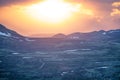 Powerful and explosive sunset with vivid colors over remote mountain road