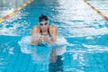 Powerful female swimmer swimming breaststroke at speed