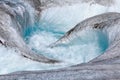 Powerful flow of the river from the melted ice on the Aktru glacier in the Altai mountains. Royalty Free Stock Photo