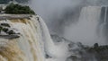 The powerful foaming streams of the waterfall collapse in the gorge. Royalty Free Stock Photo