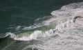 Powerful green wave with froth in sea