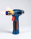 Powerful Butane Torch with Blue Flame on White Background Royalty Free Stock Photo
