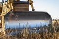 Powerful heavy crawler bulldozer works at a construction site in the evening against the background of the sky. Construction Royalty Free Stock Photo