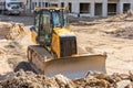 Powerful heavy crawler bulldozer works at a construction site